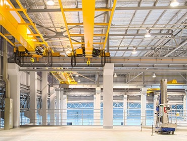 WSBL's Blackburn manufacturing hall, with overhead cranes and a mezzanine walkway.